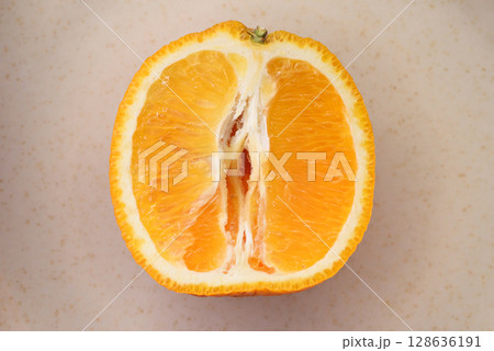 Photo of juicy halved orange. Citrus fruit macro photo 128636191