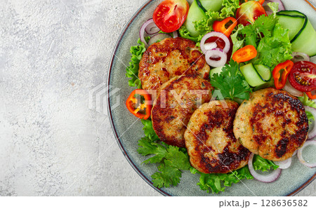 fried chicken cutlets, minced chicken, with vegetables, on gray , with vegetable salad, top view, homemade, no people, fried chicken cutlets, minced chicken, with vegetables, on gray , with vegetable salad, top view, homemade, no people, 128636582