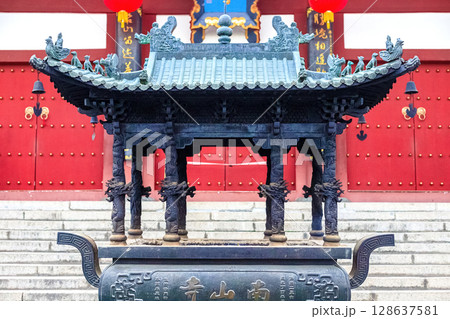 Hainan Island, Sanya: Nanshan Buddhist Center. View of the incense burner in front of the Temple Hainan Island, Sanya: Nanshan Buddhist Center. View of the incense burner in front of the Temple 128637581