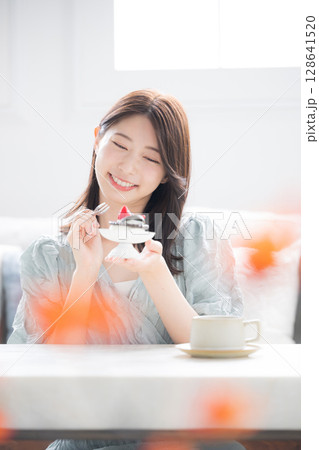 食欲の秋　甘いスイーツを笑顔で食べる女性　スイーツは別腹いただきます～　 128641520