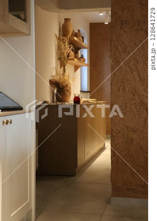 A Modern Kitchen Interior featuring Unique Wooden Elements and Stylish Decor Accessories 128641729
