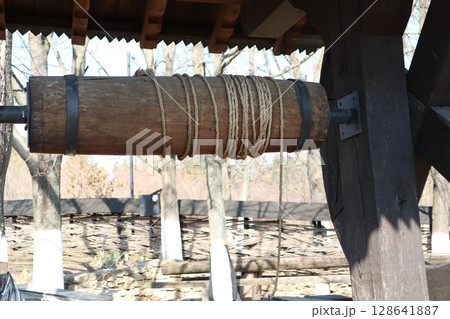 Wooden Pulley System with Rope is an ancient architectural tool used for construction and design Wooden Pulley System with Rope is an ancient architectural tool used for construction and design 128641887