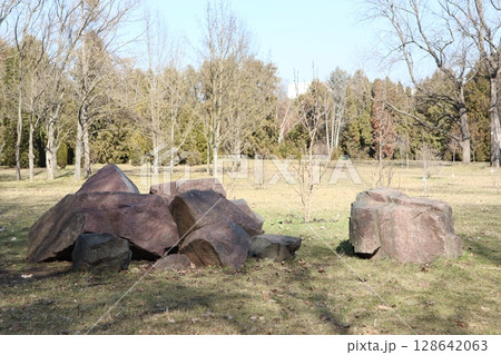 A Scenic View of Large Rocky Boulders Set Against a Lush Green Meadow Background A Scenic View of Large Rocky Boulders Set Against a Lush Green Meadow Background 128642063