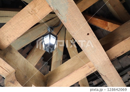 An Exquisite Wooden Ceiling Featuring a Beautiful Lantern Light Fixture for Illumination An Exquisite Wooden Ceiling Featuring a Beautiful Lantern Light Fixture for Illumination 128642069