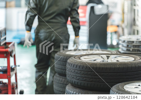 整備工場の中を歩くメカニック・整備士の中年アジア人男性 128642184