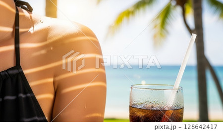 Refreshing Cola Drink with Ocean and Palm Trees on Sunny Tropical Beach Vacation Refreshing Cola Drink with Ocean and Palm Trees on Sunny Tropical Beach Vacation 128642417