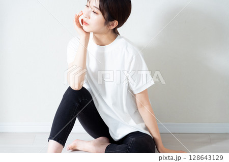 床に座る若い女性のポートレート 128643129