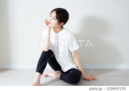 床に座る若い女性のポートレート 128643130