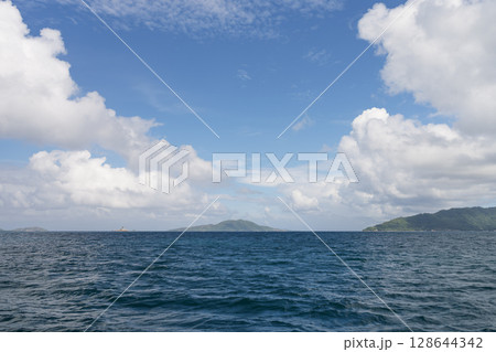 Side view from boat in Indian ocean sailing between Seychelles islands in daytime Side view from boat in Indian ocean sailing between Seychelles islands in daytime 128644342