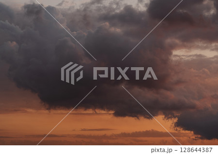 Sunset clouds in the sky in summer evening Sunset clouds in the sky in summer evening 128644387