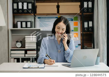 Asian business woman have the joy of talking on the smartphone, tablet and laptop video call on the modern office Asian business woman have the joy of talking on the smartphone, tablet and laptop video call on the modern office 128644573