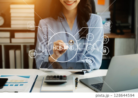 Web hosting concept, business using computer and presses his finger on the virtual screen inscription Hosting on desk, Internet, business, Technology concept. 128644594