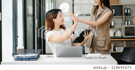Portrait of success business people working together in office. Couple teamwork startup concept 128645073