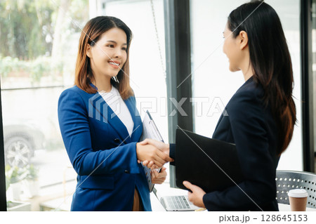 Business partnership handshake concept.Photo two coworkers handshaking process.Successful deal after great meeting. 128645153
