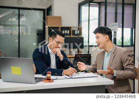 Business and lawyers discussing contract papers with brass scale on desk in office. Law, legal services, advice,  justice and law concept . 128645468