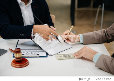 Business law concept, Lawyer business lawyers are consulting lawyers for women entrepreneurs to file copyright lawsuit with laptop and tablet at office 128645562