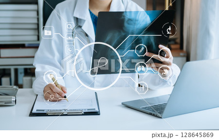 Medicine doctor using digital tablet and smartphone diagnose virtual electronic medical record on interface.Digital healthcare and network on virtual screen Medicine doctor using digital tablet and smartphone diagnose virtual electronic medical record on interface.Digital healthcare and network on virtual screen 128645869