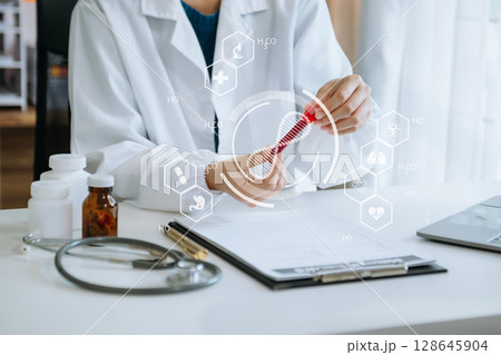 DNA molecule testing concepts. The doctor in a mask examines DNA molecules on the chemical laboratory with virtual icon screen DNA molecule testing concepts. The doctor in a mask examines DNA molecules on the chemical laboratory with virtual icon screen 128645904