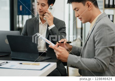 Business team meeting,work process.professional crew working with new startup project.Project managers. business plans, Laptop smartphone hands. Business team meeting,work process.professional crew working with new startup project.Project managers. business plans, Laptop smartphone hands. 128646424