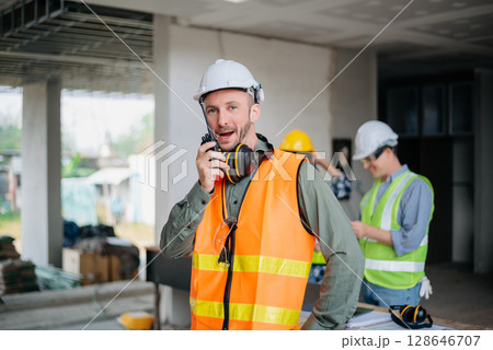 Engineers are discussing data working and laptop or tablet with architectural project at new construction site on big project. 128646707