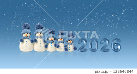 Knitted toys snowmen in blue hat and scarf with blue numbers 2026 on blue background. Merry Christmas and New Year 2026 greeting card Knitted toys snowmen in blue hat and scarf with blue numbers 2026 on blue background. Merry Christmas and New Year 2026 greeting card 128646844
