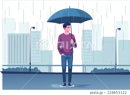 A young man stands with an umbrella in the rain. 128653122