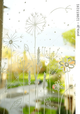 Floral Art on Window Glass Capturing Outdoor Beauty 128653191