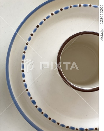 Ceramic donut-shaped tray with brown and blue accents, perfect for serving or as background 128653200