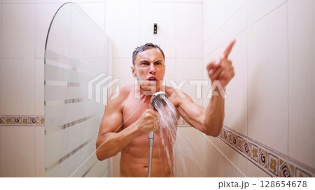 Man singing energetically and pointing finger while taking shower Man singing energetically and pointing finger while taking shower 128654678