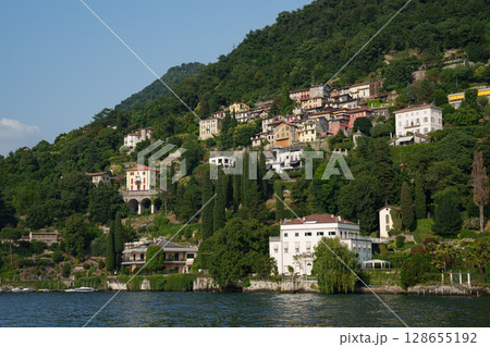 Villas on the shores of Lake Como, Italy - Summer landscape with hills and architecture. Villas on the shores of Lake Como, Italy - Summer landscape with hills and architecture. 128655192