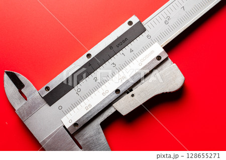 Close-up of a caliper on a bright saturated background. A tool for precise and accurate measurement 128655271