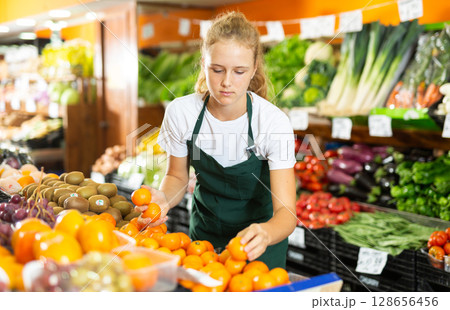 Girl at her first job in vegetable shop Girl at her first job in vegetable shop 128656456