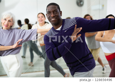 Positive African American man practicing vigorous dance 128656496