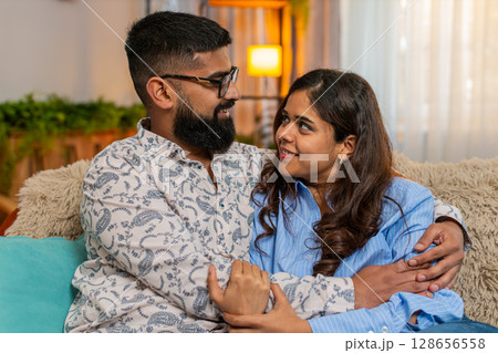 Indian couple man woman hugging and smiling after reconciliation, peaceful emotional moment together Indian couple man woman hugging and smiling after reconciliation, peaceful emotional moment together 128656558