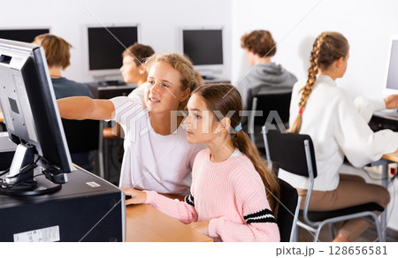 Portrait of female and male students working on computers in class room Portrait of female and male students working on computers in class room 128656581