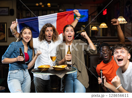 Group of France football team fans spending time in bar Group of France football team fans spending time in bar 128656611