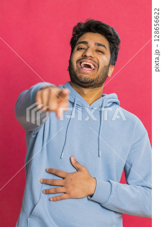 Happy excited Indian man laughing out loud after hearing ridiculous anecdote, reaction on funny joke Happy excited Indian man laughing out loud after hearing ridiculous anecdote, reaction on funny joke 128656622