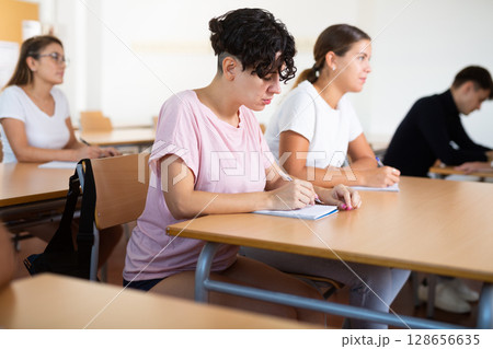 Woman attending lecture in college 128656635