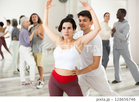 Adult couple of dancers learns partner dance 128656746