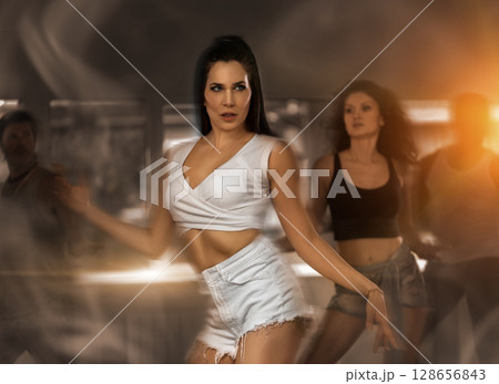 Group of girls learning to dance modern dances on high heels 128656843