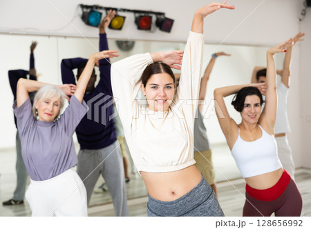 Young girl enjoying practicing passionate bachata during group class Young girl enjoying practicing passionate bachata during group class 128656992