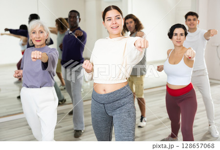 Girl practicing punches during group self defense course 128657068
