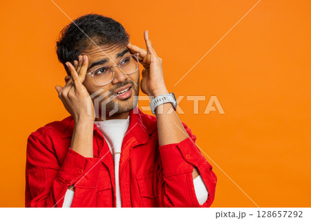 Indian man rubbing temples to cure headache problem, suffering from tension and migraine stress pain Indian man rubbing temples to cure headache problem, suffering from tension and migraine stress pain 128657292