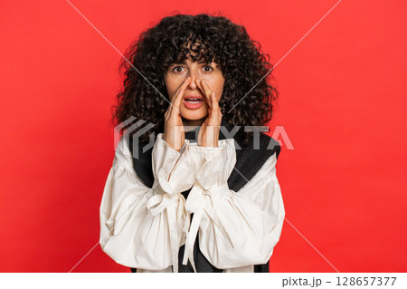 Young woman whisper news rumors holding hands near mouth, share gossip, quiet, keep my secrets 128657377