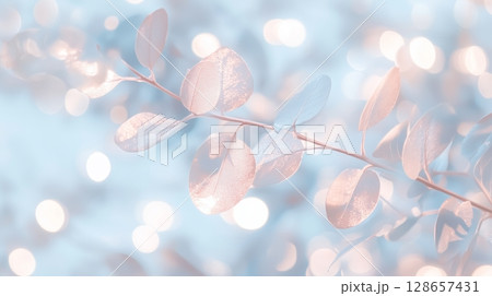 Elegant metallic leaves with bokeh effect in soft blue 128657431