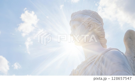 Serene marble statue with soft lighting and cloudy sky 128657547