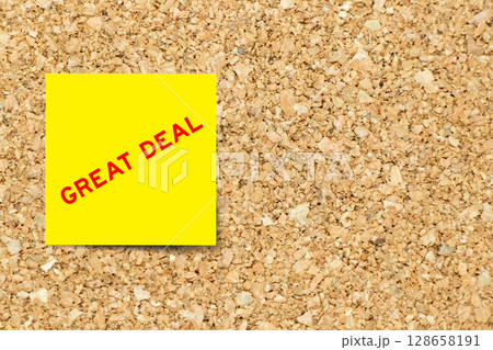 Yellow note paper with word great deal on cork board background with copy space 128658191