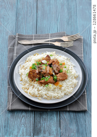 beef slow cooked with gravy served over rice beef slow cooked with gravy served over rice 128661478