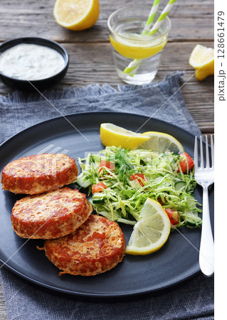 Hot Smoked salmon burgers, patties and coleslaw 128661479