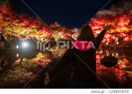 tourist woman raise hands and view autumn colors, Toji temple, Kyoto 128661639